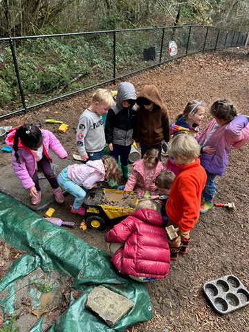 Children playing outdoors in the rain